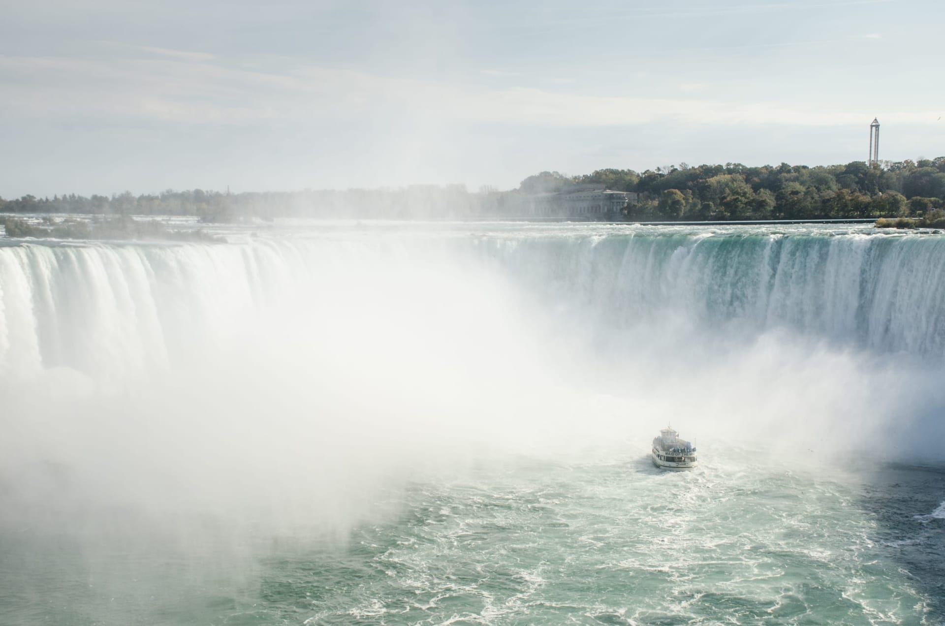 Maid of the Mist boat emerging from the mist wall beneath Horseshoe Falls, Niagara